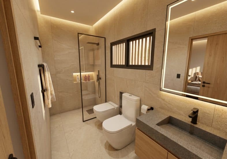 Baño completo de la vivienda tipo, con cerámicos claros y sanitarios blancos